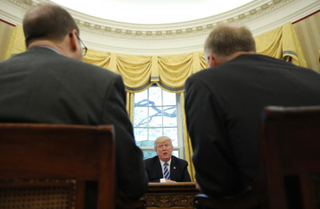 President Trump tells Reuters reporters during an interview in the Oval Office, “This is more work than in my previous life. I thought it would be easier.” (Carlos Barria/Reuters)